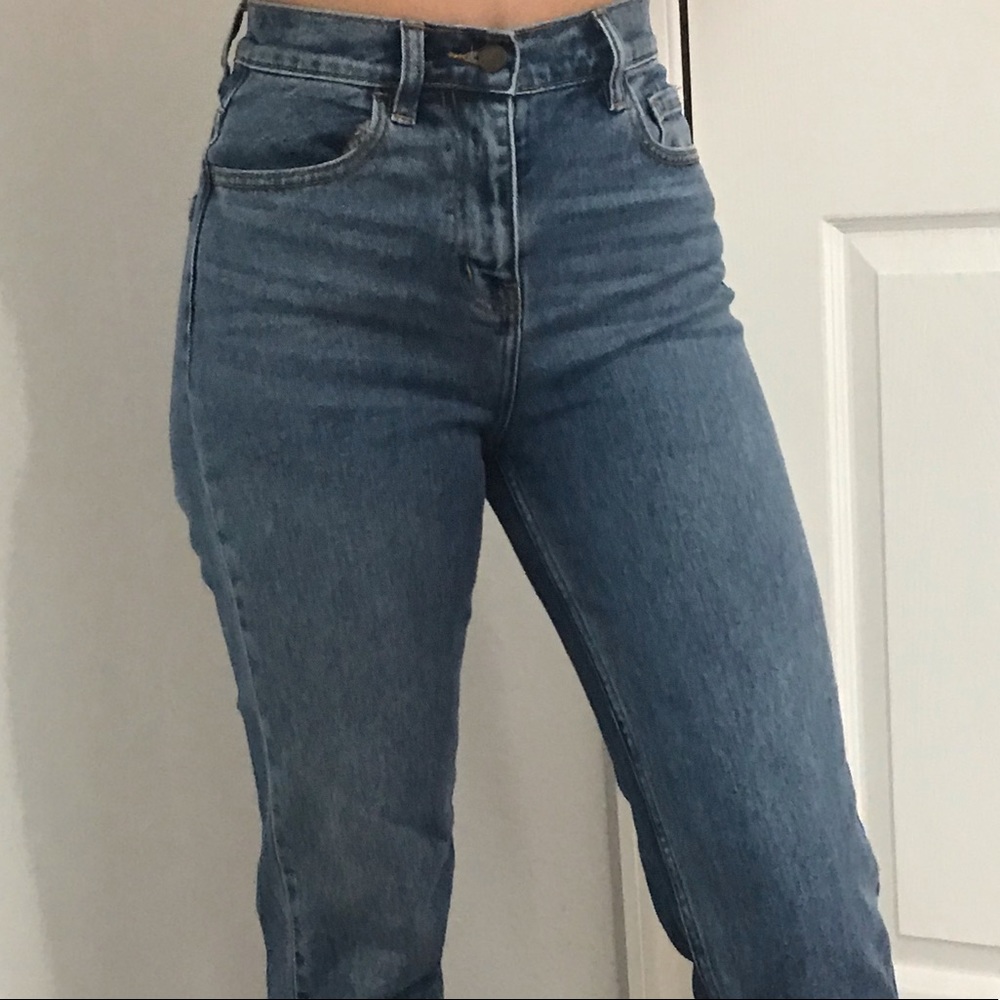A pair of blue Fashion Nova high waisted mom jeans